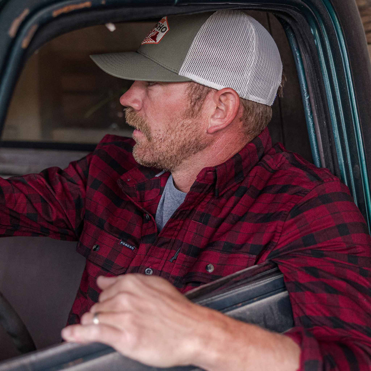 guy in truck wearing red plaid flannel 