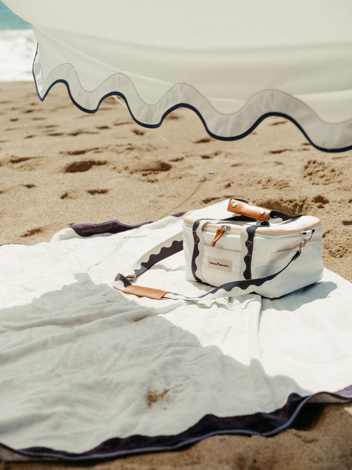 Riviera white tent with matching accessories on the beach